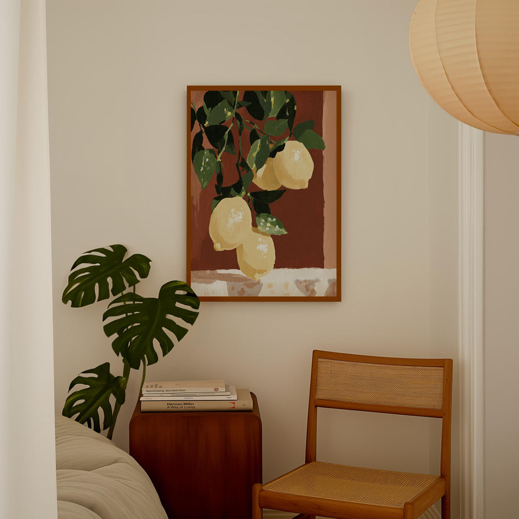 a cozy corner of a room with a wooden chair, a wooden side table, and a framed painting of lemons hanging on the wall.