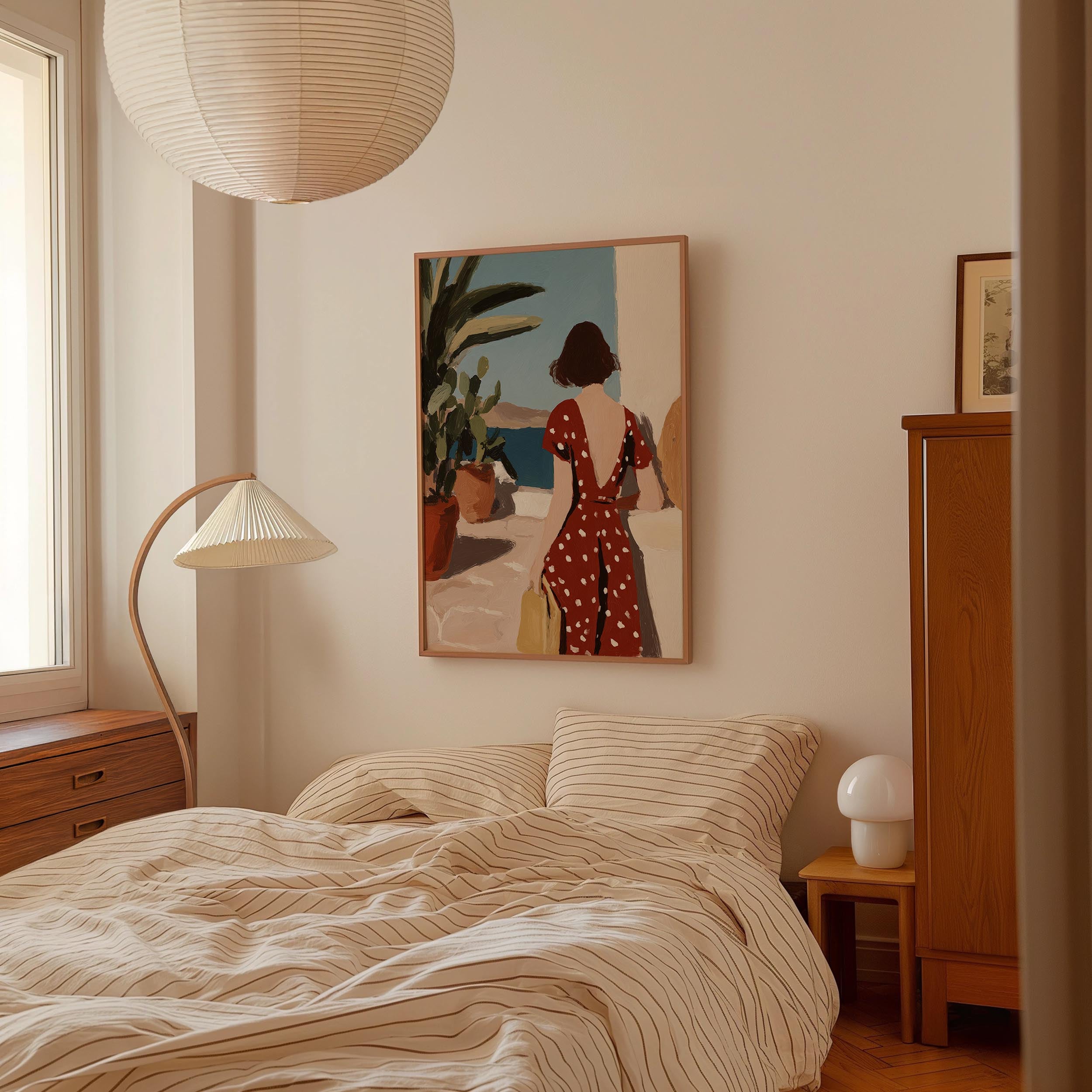 a bedroom with a bed, a lamp, and a painting on the wall.