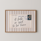 The image is a framed print with a postcard-like design, featuring a handwritten message and a postage stamp.