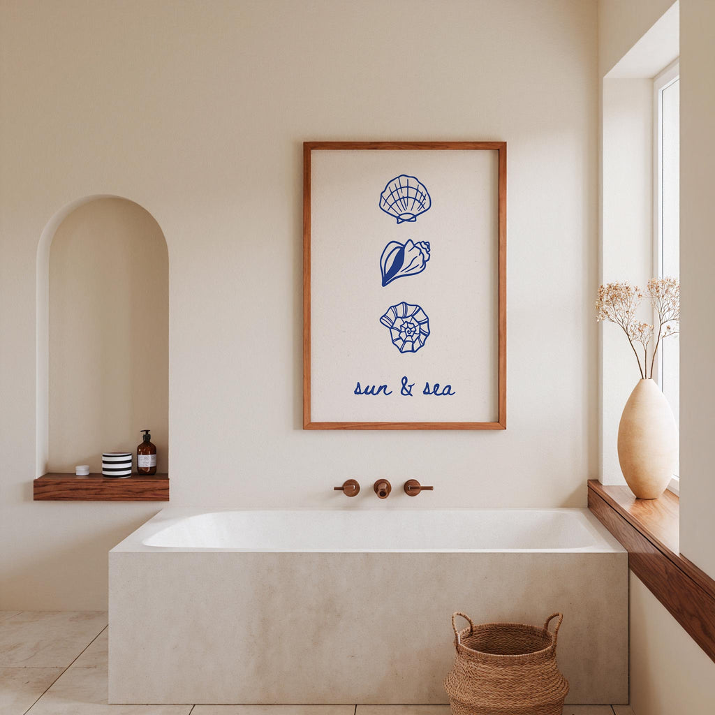 a bathroom with a white bathtub, a framed artwork with seashells and the words "sun & sea" above it, and a window with a vase of flowers.