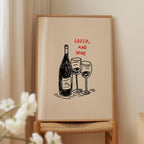 a framed illustration of a wine bottle and two wine glasses, accompanied by the text "Gossip, and wine" in red letters.