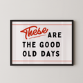 a framed poster with the text "These are the good old days" in bold, red and black lettering.