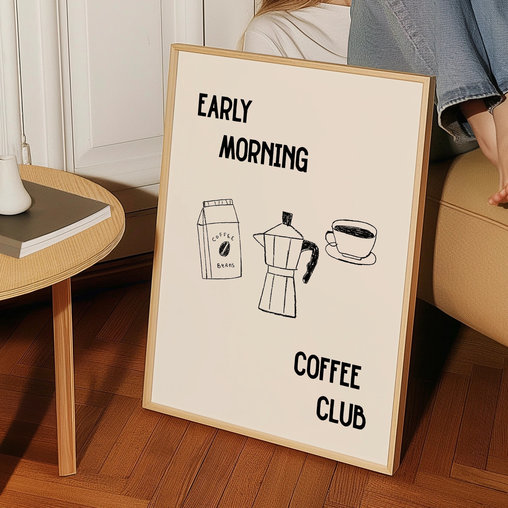 a framed poster with the text "Early Morning Coffee Club" and illustrations of a coffee maker and a cup of coffee.