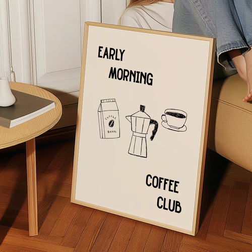 a framed poster with the text "Early Morning Coffee Club" and illustrations of a coffee maker and a cup of coffee.