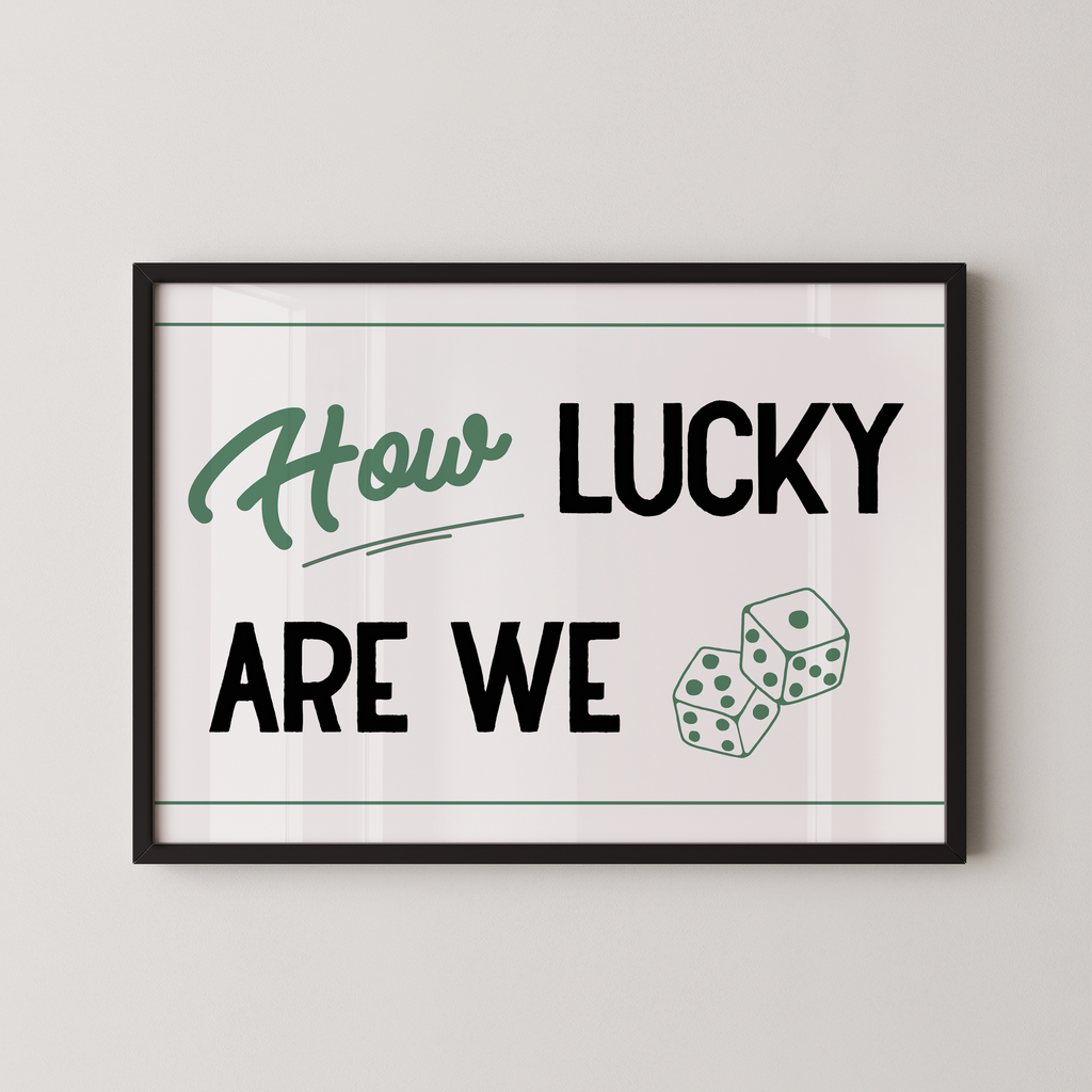 A framed poster with the text "How LUCKY ARE WE" and two dice graphics.