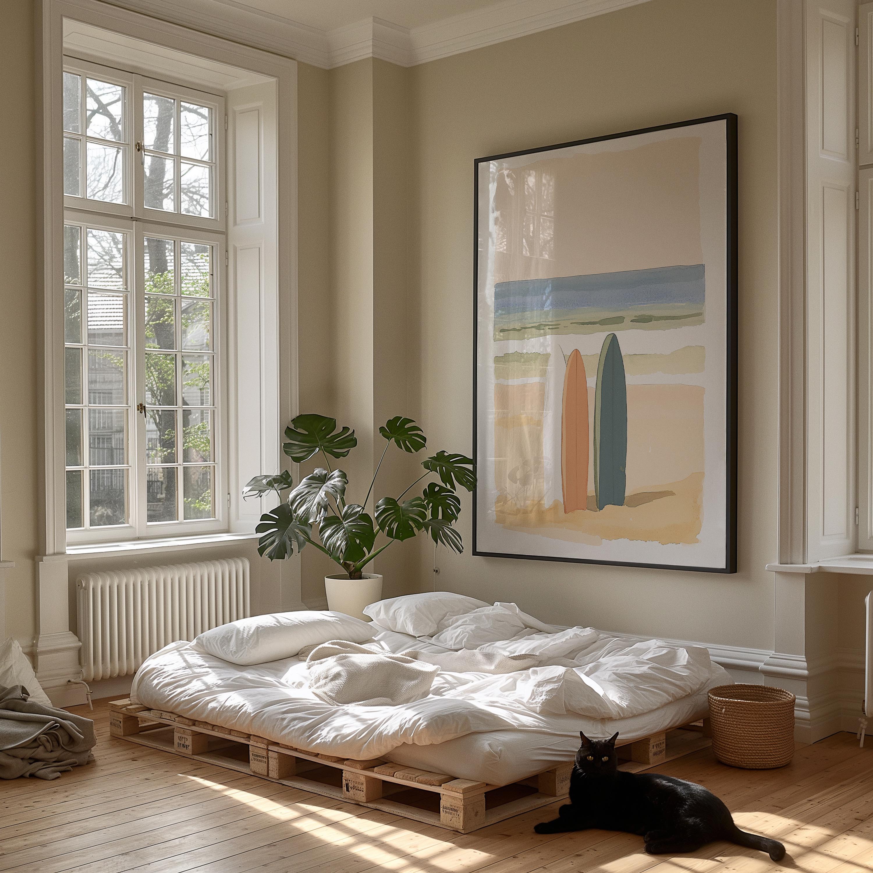 A cozy bedroom with a bed, a large framed picture of a beach scene, and a black cat sitting on the floor.