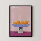 A framed illustration of a bowl containing three oranges on a pink background.