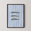 three fish swimming against a blue and white striped background.