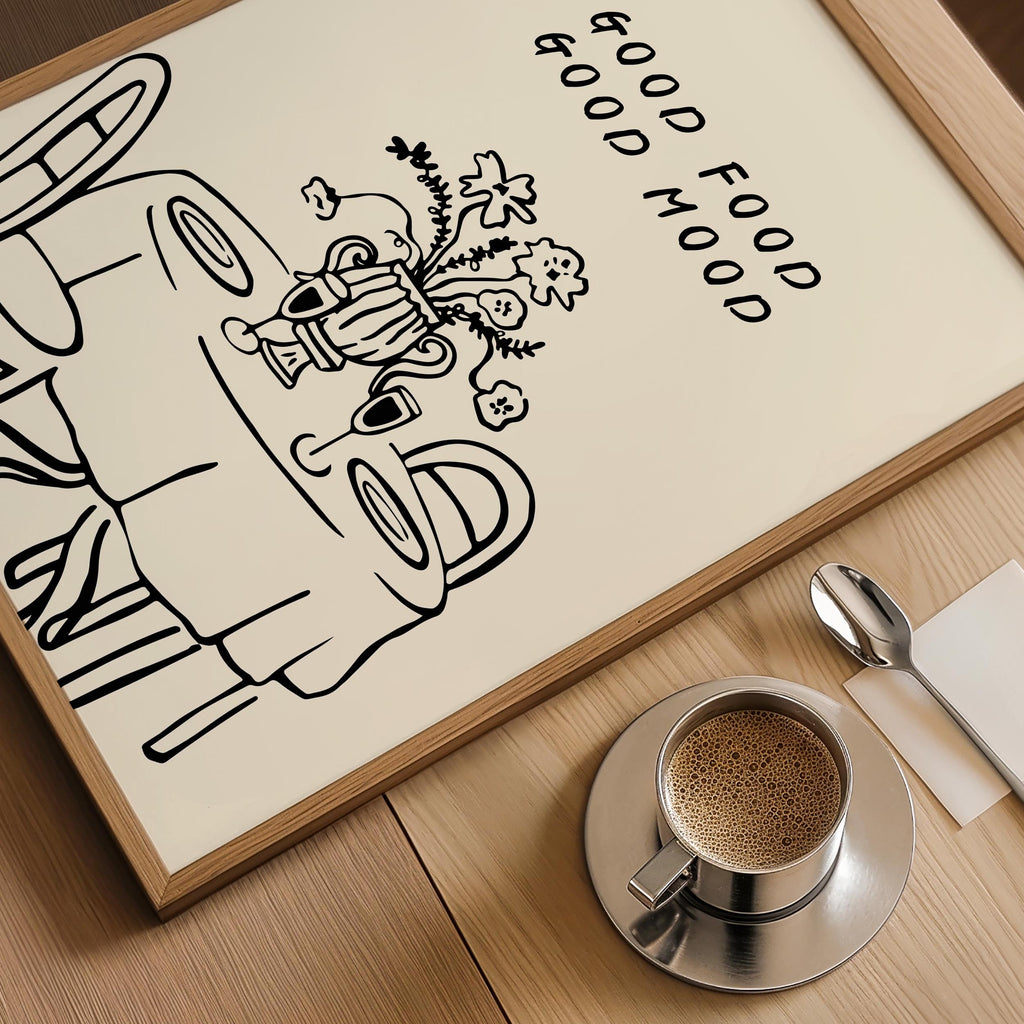 A framed illustration of a table with a vase of flowers, accompanied by the text "GOOD FOOD GOOD MIND" on a wooden surface.