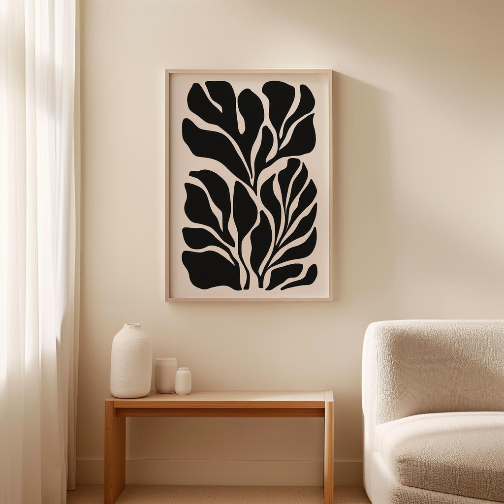 a minimalist living room with a large black and white abstract artwork hanging on the wall above a wooden table with three small white vases on it.