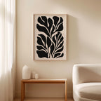a minimalist living room with a large black and white abstract artwork hanging on the wall above a wooden table with three small white vases on it.