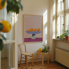 a cozy corner of a room with a wooden chair, a small table with fruit, and a framed artwork of oranges on a wall.