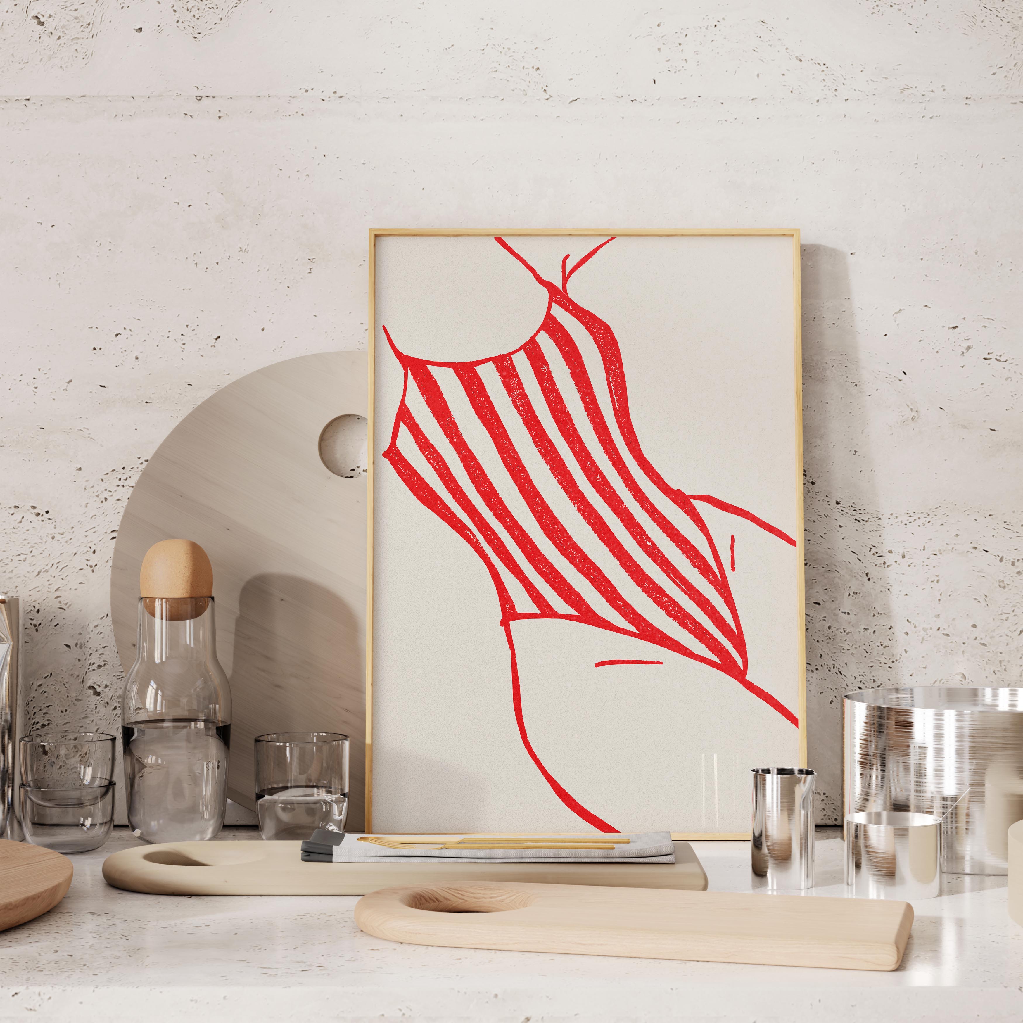 a framed artwork of a red and white striped swimsuit, displayed on a shelf alongside various kitchen items such as a glass bottle, a wooden cutting board, and a metal container.