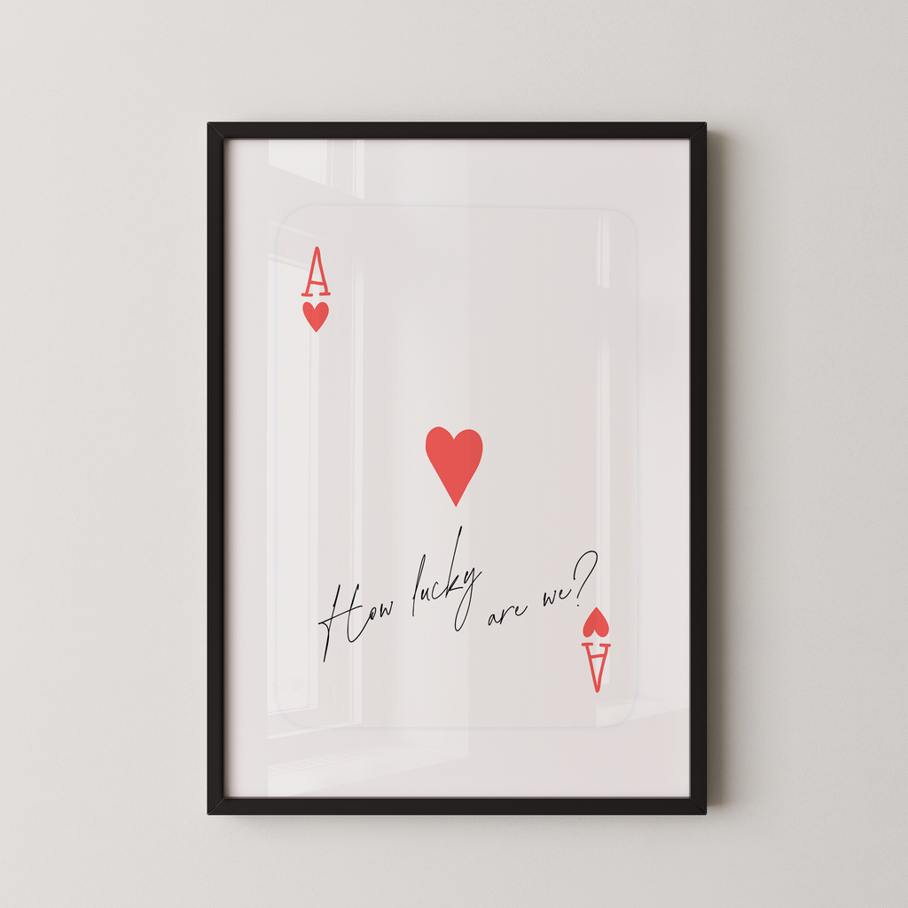 The image is a framed print with a red heart and the text "How lucky are we?" written on it.