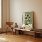 a minimalist interior design with a wooden chair, a wooden bench, a vase, and a framed painting of a plant on a table.