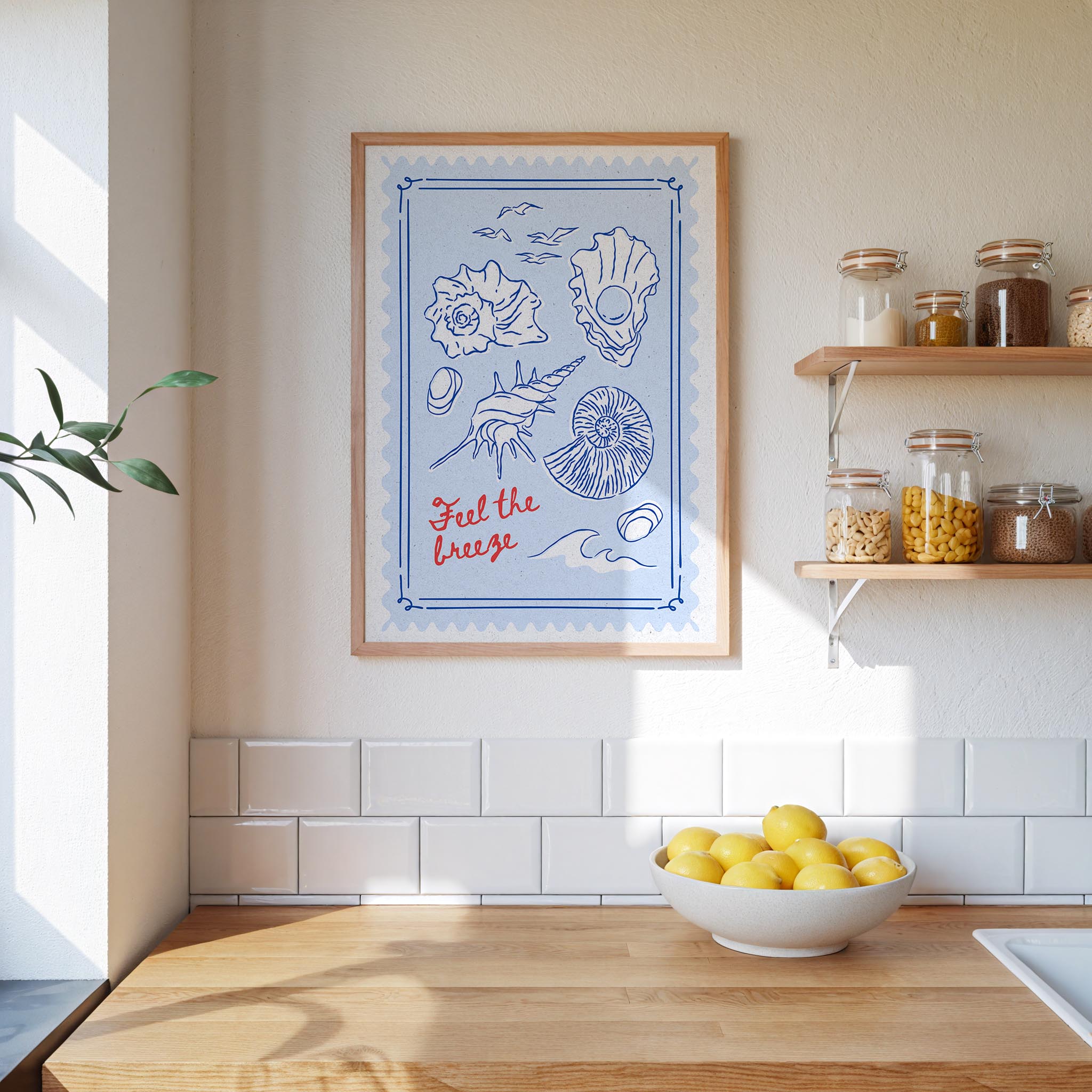 a kitchen counter with a bowl of lemons, a framed poster with illustrations of shells and a wave, and a shelf with jars and containers.
