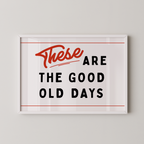 a framed poster with the text "These are the good old days" in a bold, red font.