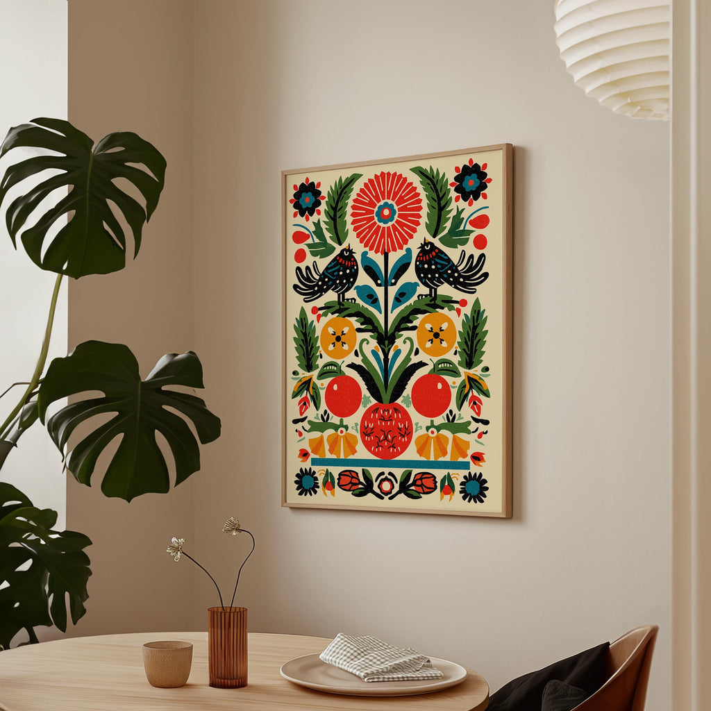 a vibrant, colorful painting hanging on a wall above a wooden table. The painting is a lively depiction of various fruits and flowers, with a large red flower at the center. The table is set with a vase of flowers and a plate of food, creating a cozy and inviting atmosphere.