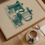 a framed illustration of a coffee maker and a cup of coffee on a wooden table.