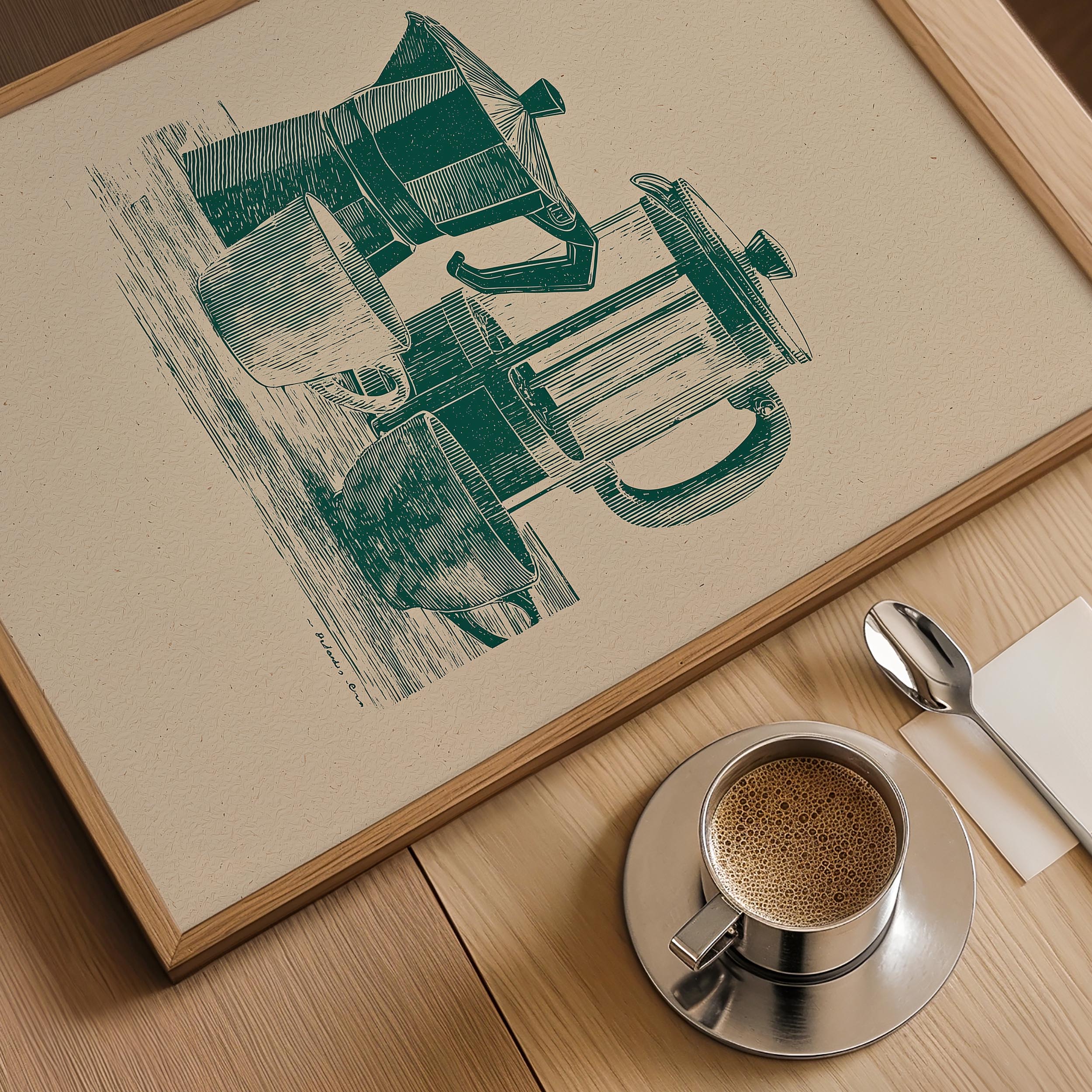 a framed illustration of a coffee maker and a cup of coffee on a wooden table.