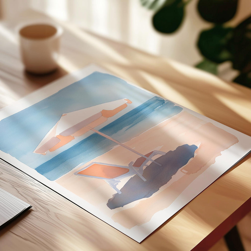 a painting of a beach scene with two umbrellas and a lounge chair, placed on a wooden surface.