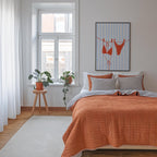a cozy bedroom with a large bed, a wooden stool with a potted plant, and a striped artwork on the wall.