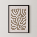 a framed abstract art print with a stylized tree-like design in shades of brown and beige.