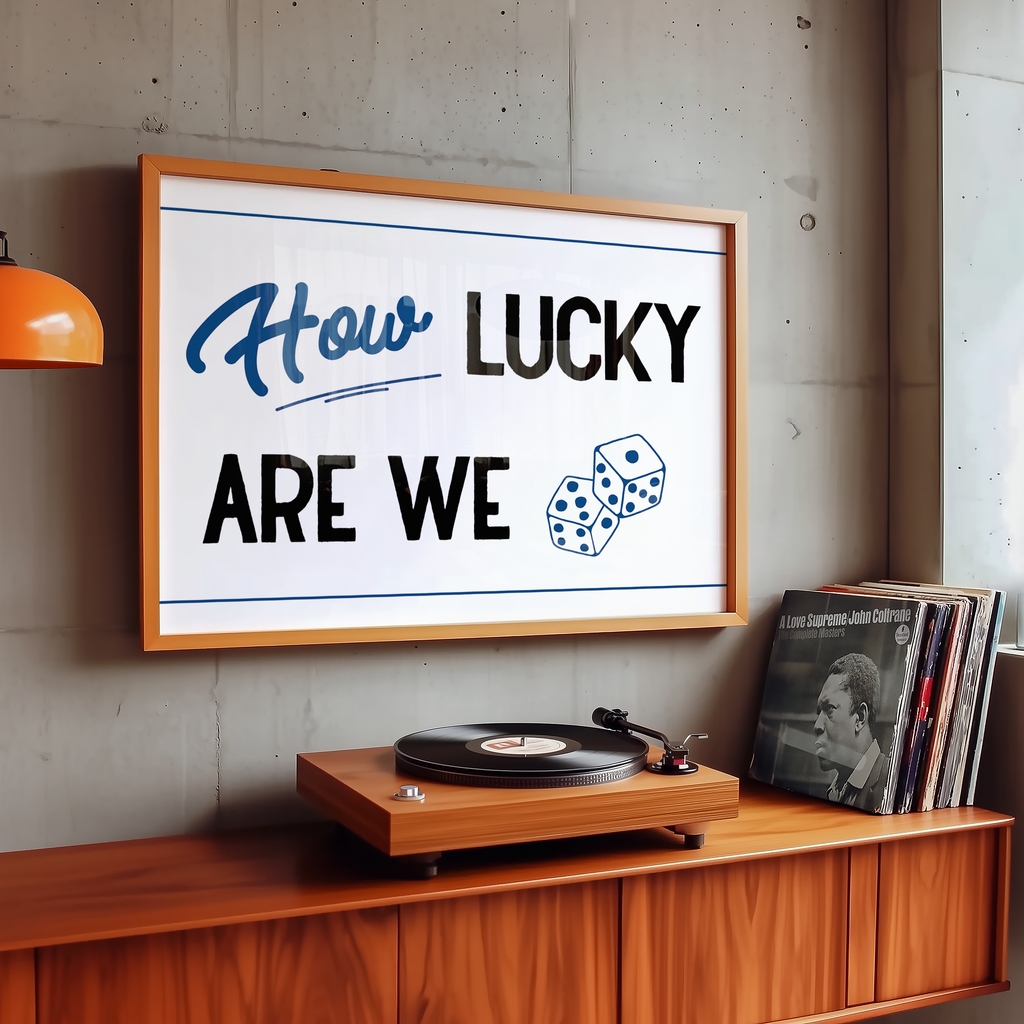 A framed poster with the text "How LUCKY ARE WE" hangs on a wall above a wooden record player and a collection of vinyl records.
