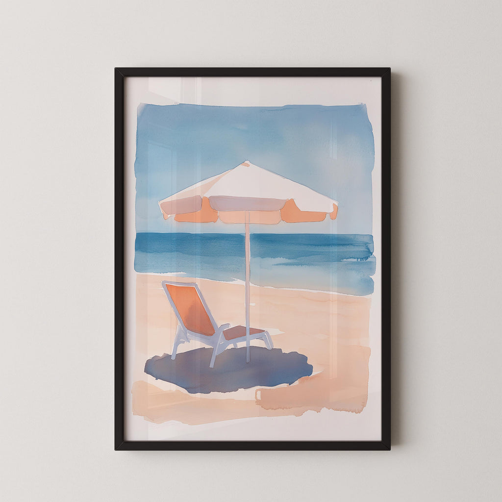 A framed watercolor painting depicting a beach scene with a beach chair under an umbrella, set against a backdrop of the ocean.
