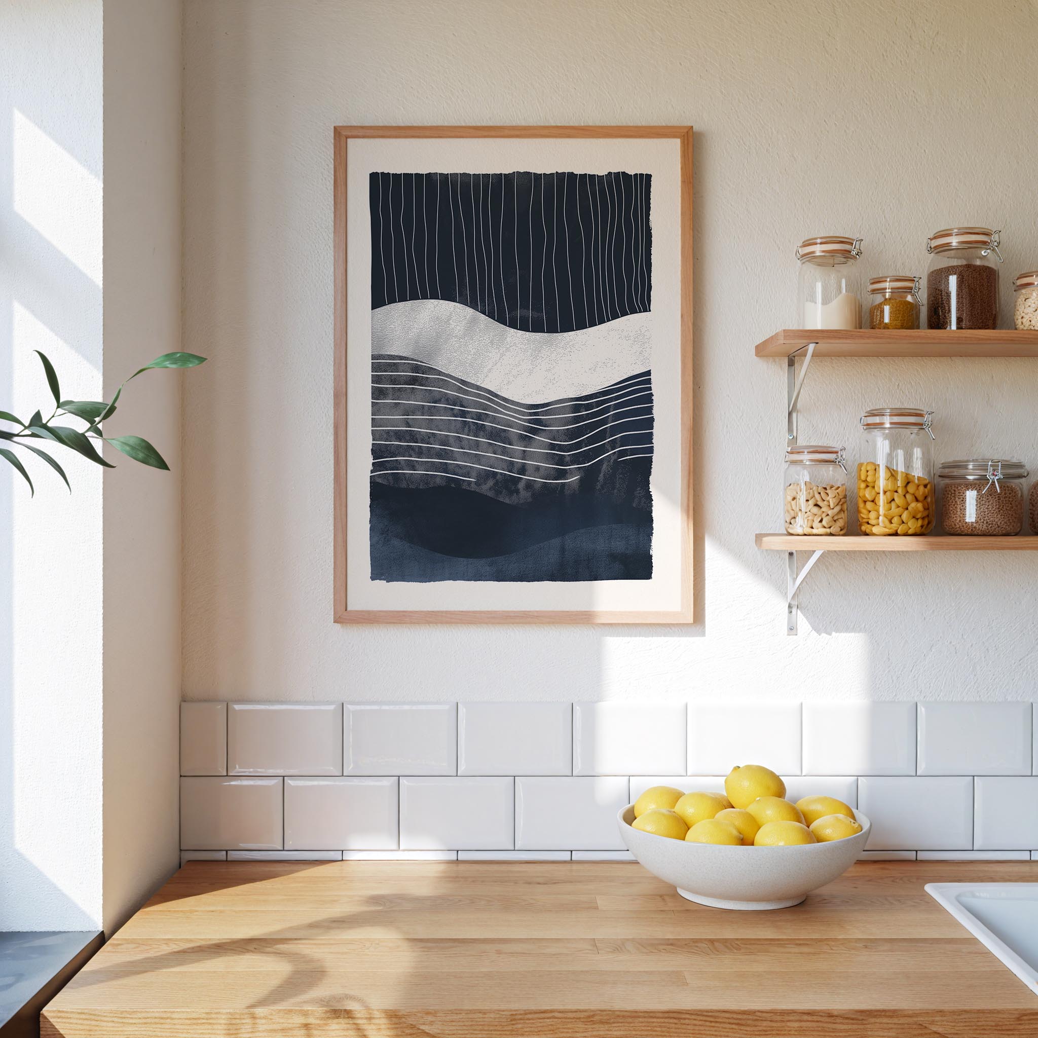 a kitchen counter with a bowl of lemons, a framed abstract art piece, and a shelf with various jars and containers.