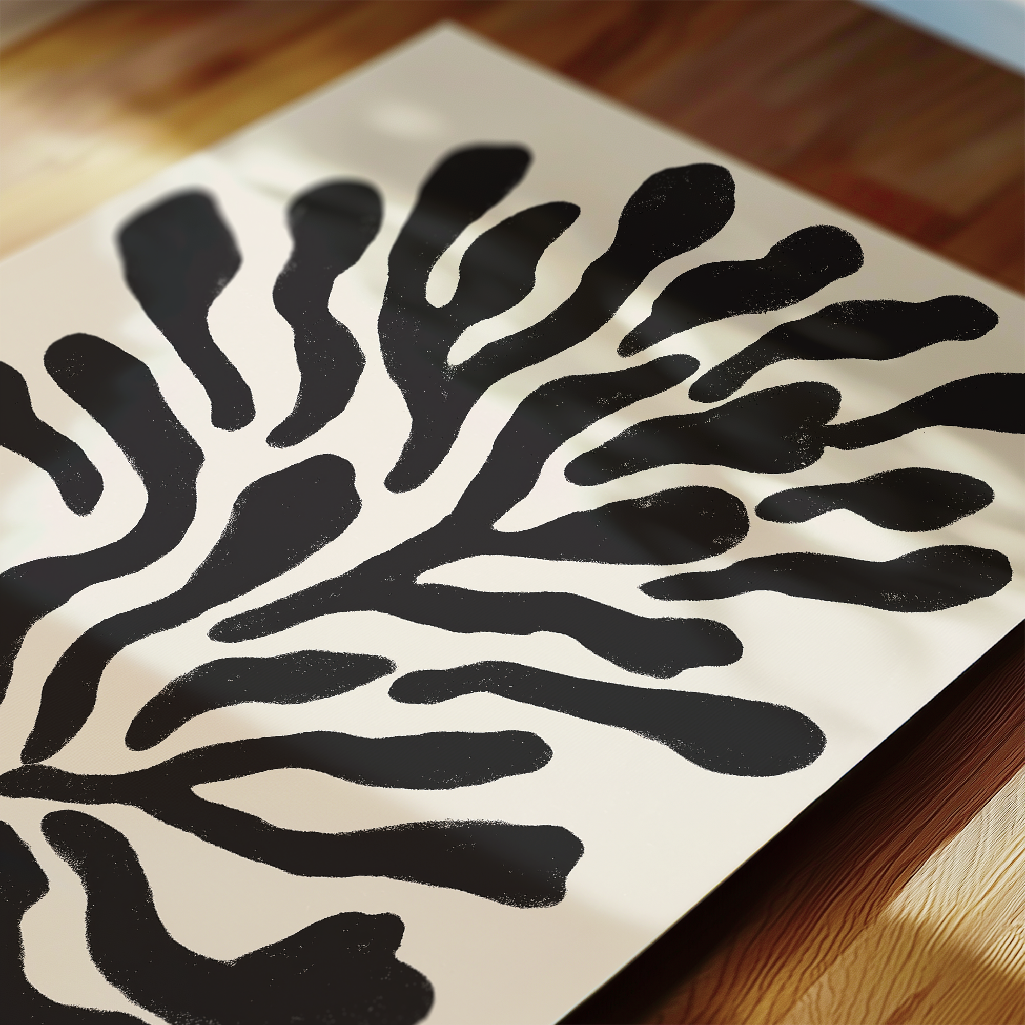 a close-up view of a piece of paper with a striking black and white abstract design resembling a stylized tree or plant.