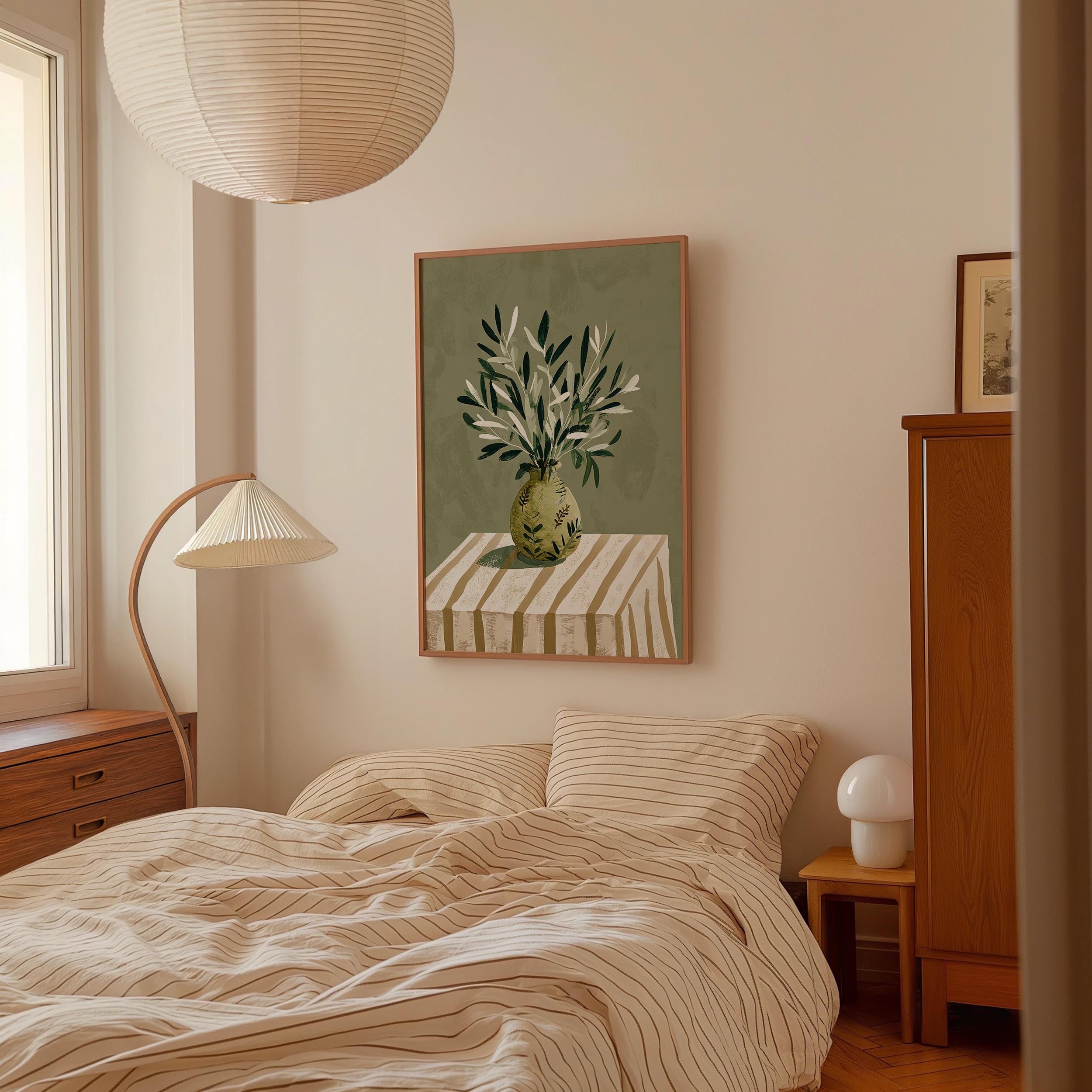 a cozy bedroom with a bed, a lamp, and a framed artwork on the wall.