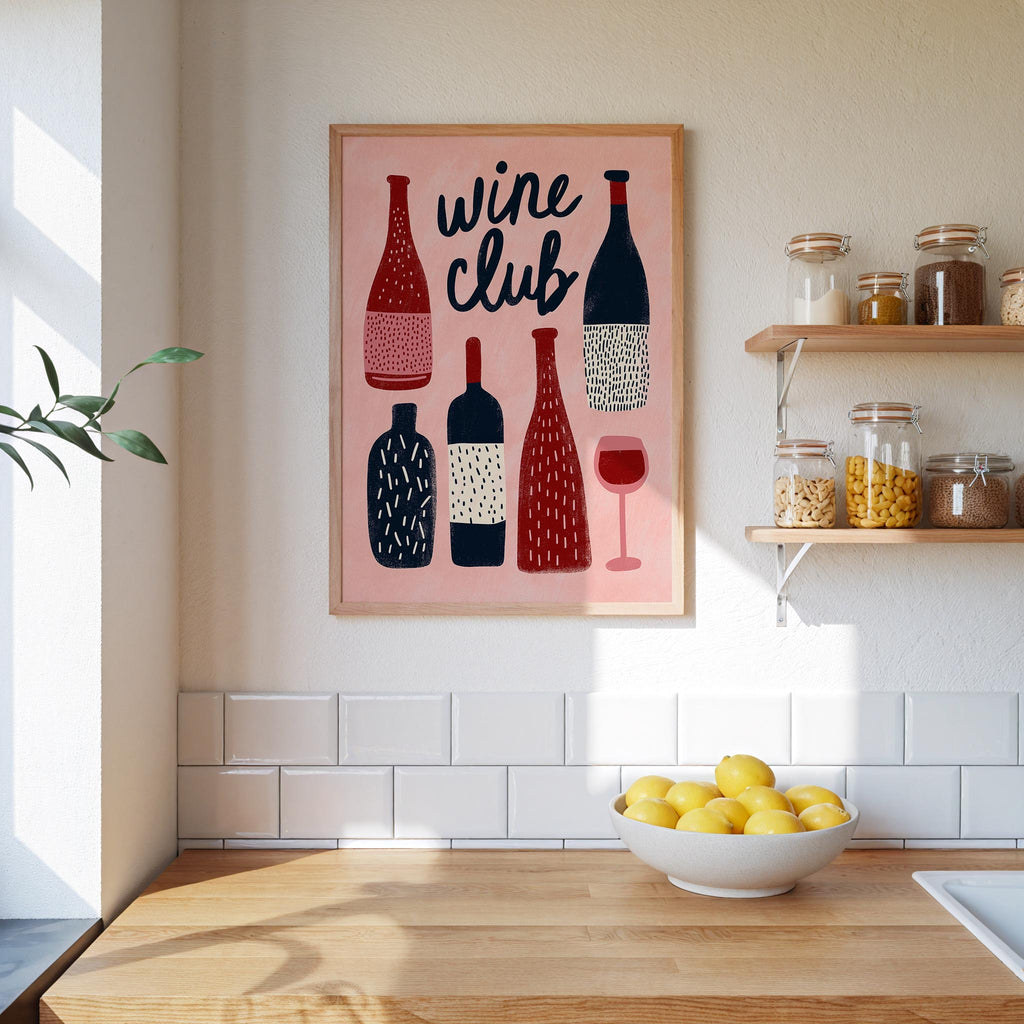 a kitchen counter with a bowl of lemons, a framed poster of wine bottles, and shelves with various jars and containers.