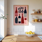 a kitchen counter with a bowl of lemons, a framed poster of wine bottles, and shelves with various jars and containers.