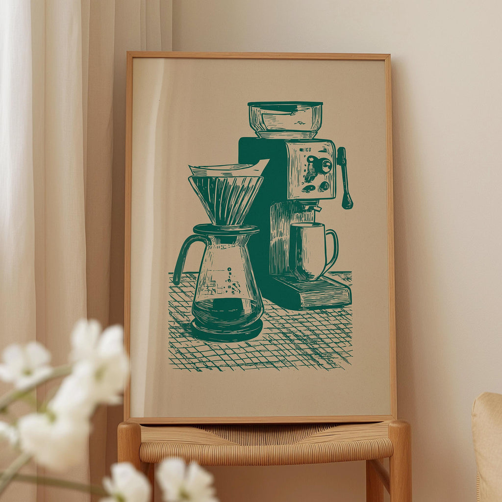 a framed illustration of a coffee maker and a coffee grinder on a table.