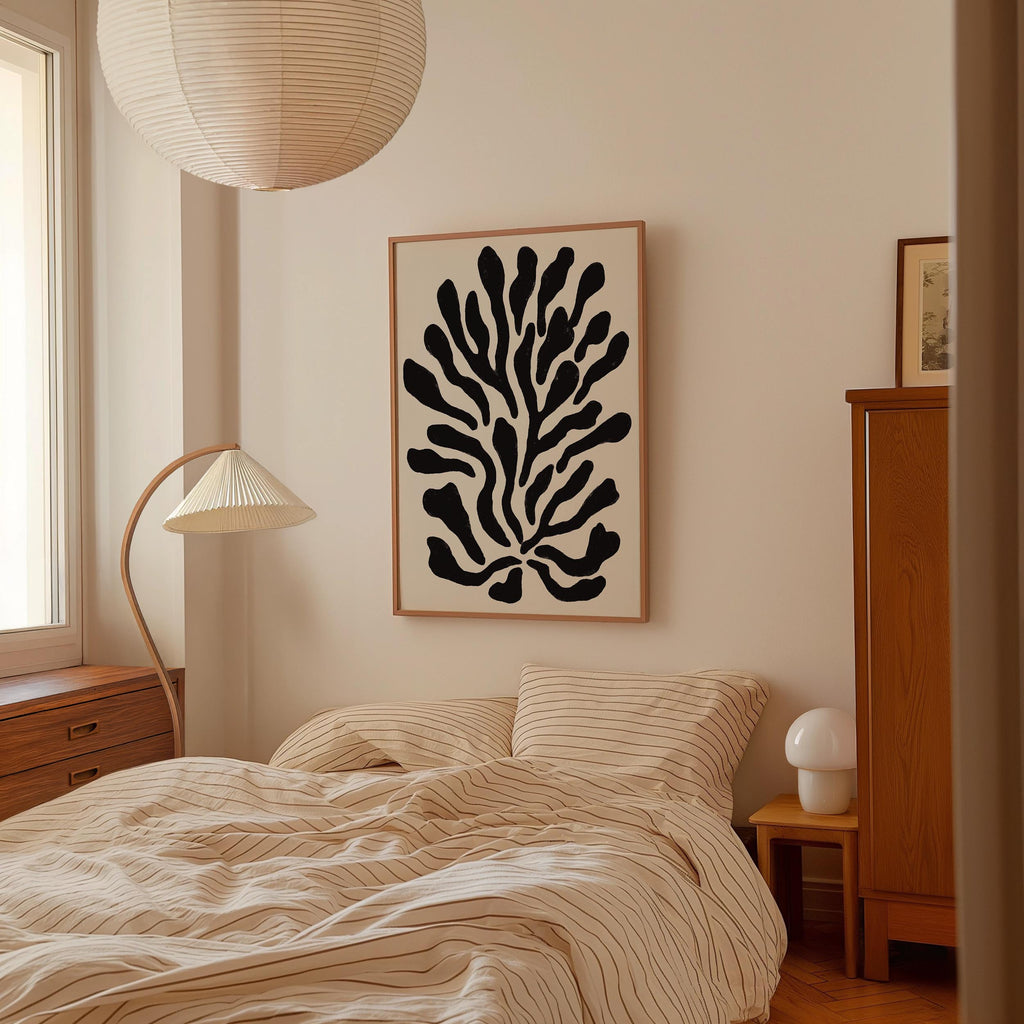 a bedroom with a bed, a lamp, and a framed abstract artwork on the wall.