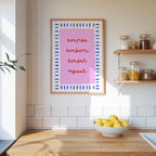 a kitchen counter with a bowl of lemons, a framed quote, and various kitchen items such as jars and a plant.