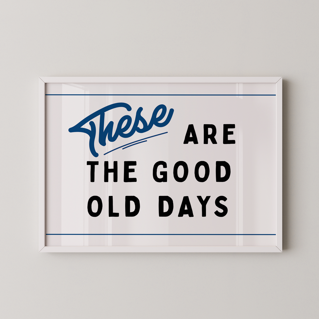 a framed poster with the text "These are the good old days" in a blue cursive font.