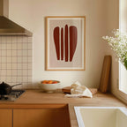 a kitchen counter with a bowl of fruit, a vase of white flowers, and a framed abstract art piece on the wall.