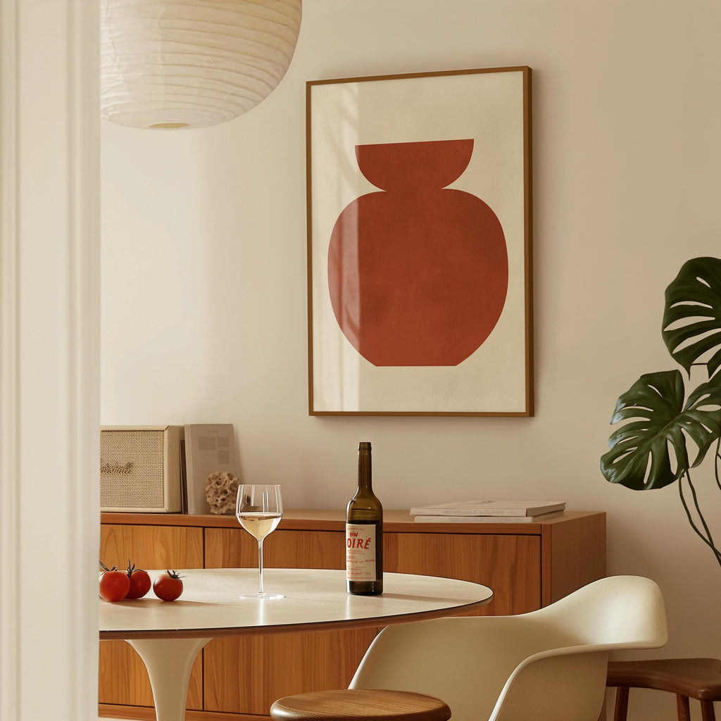 a dining room with a table set for two, a bottle of wine, and a framed abstract artwork on the wall.