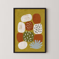 The image is a framed abstract art piece featuring a variety of colorful shapes and patterns, including circles, ovals, and splashes of color.