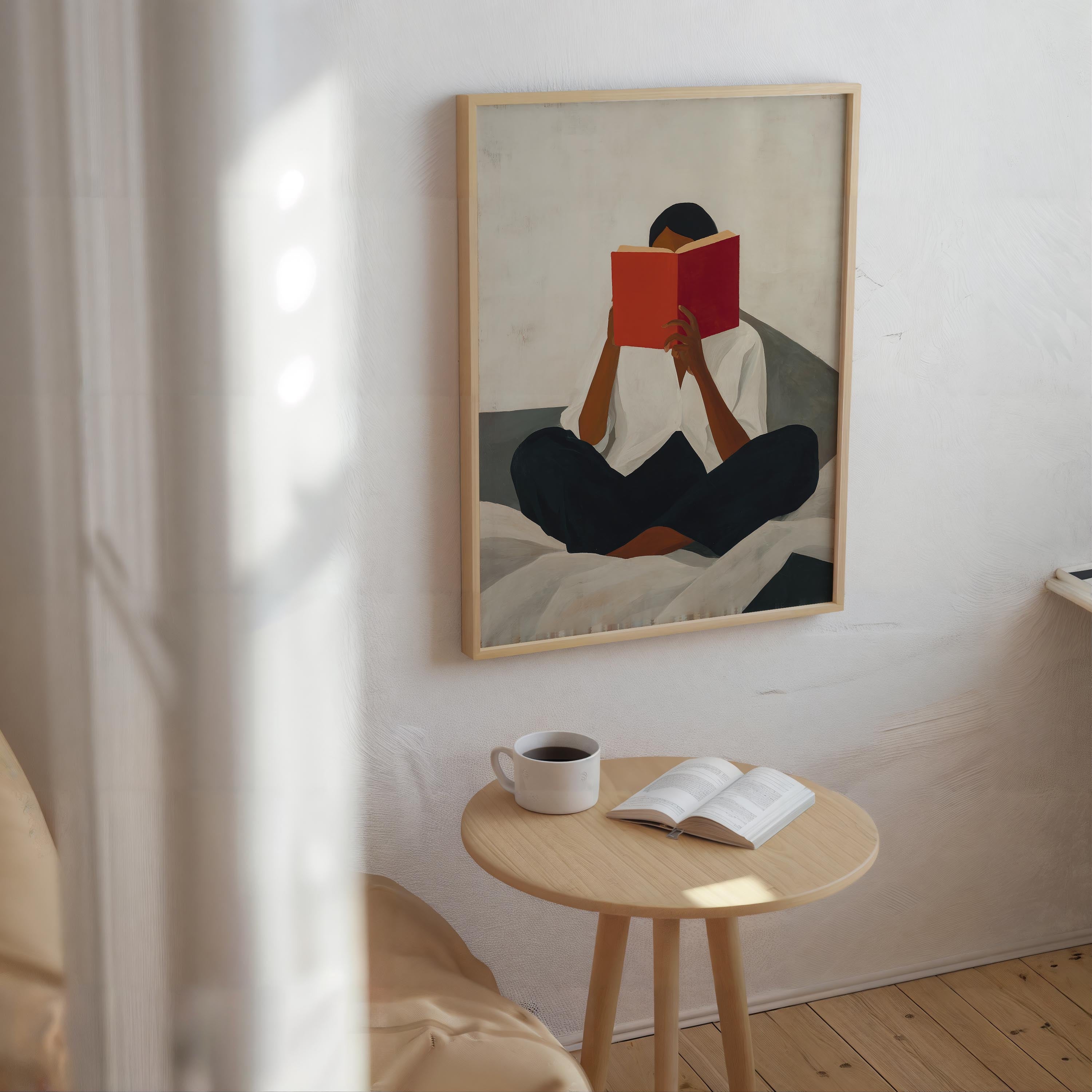 a person sitting on a bed, reading a book, with a cup of coffee and a small table nearby.
