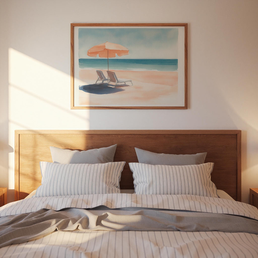 a serene bedroom scene with a wooden headboard, a striped comforter, and a framed painting of a beach scene above the bed.