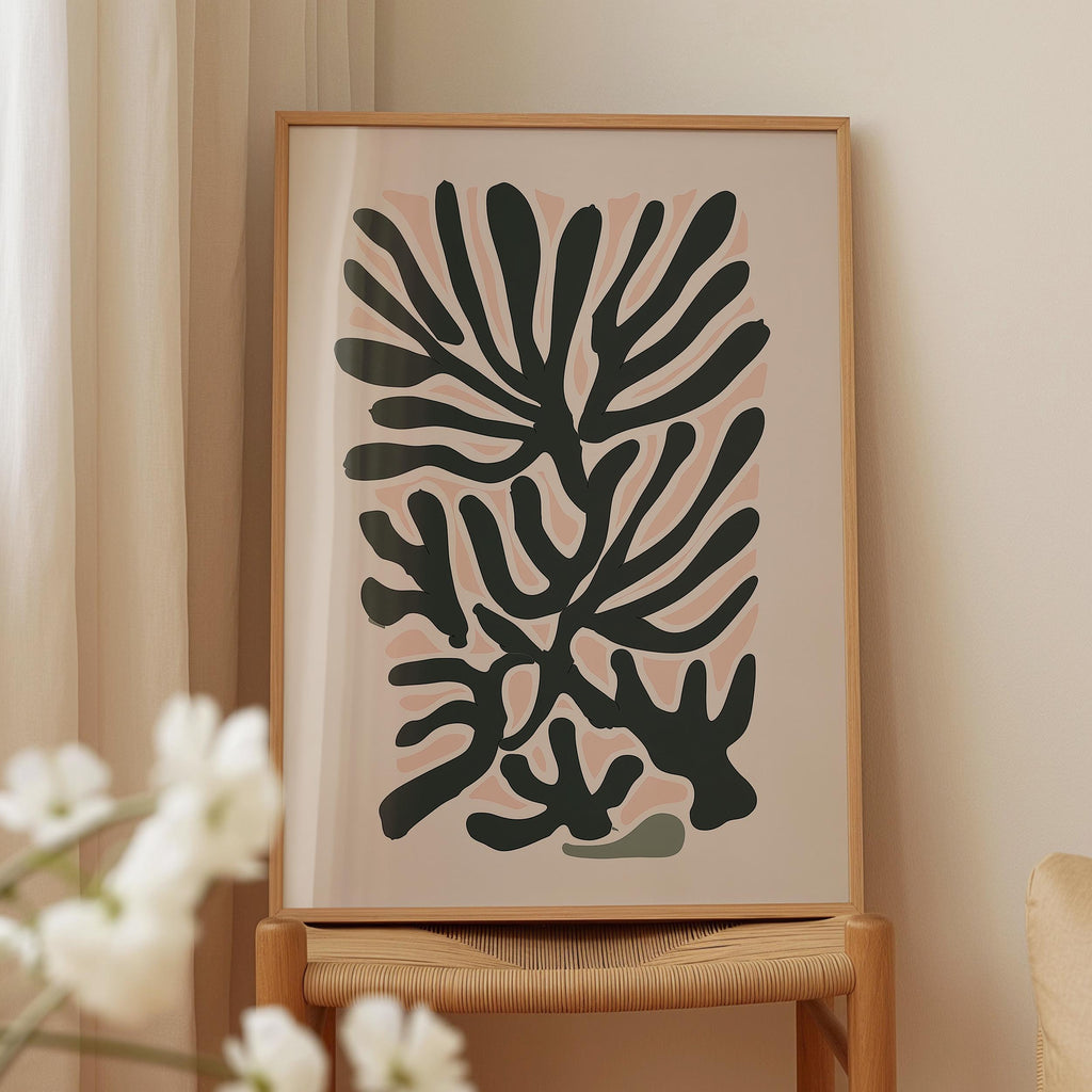 a framed abstract art piece with a black and white color scheme, displayed on a wooden stand.