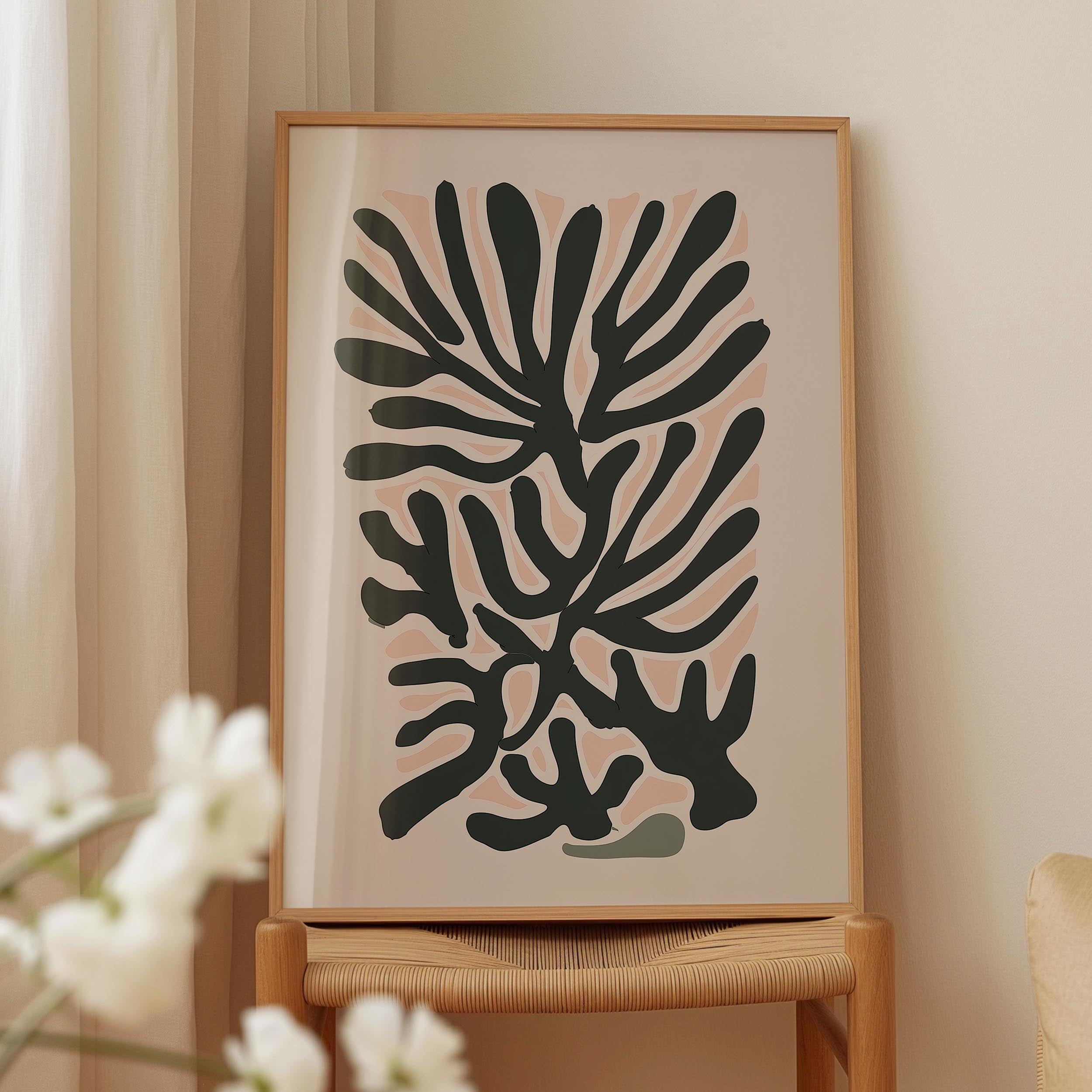 a framed abstract art piece with a black and white color scheme, displayed on a wooden stand.