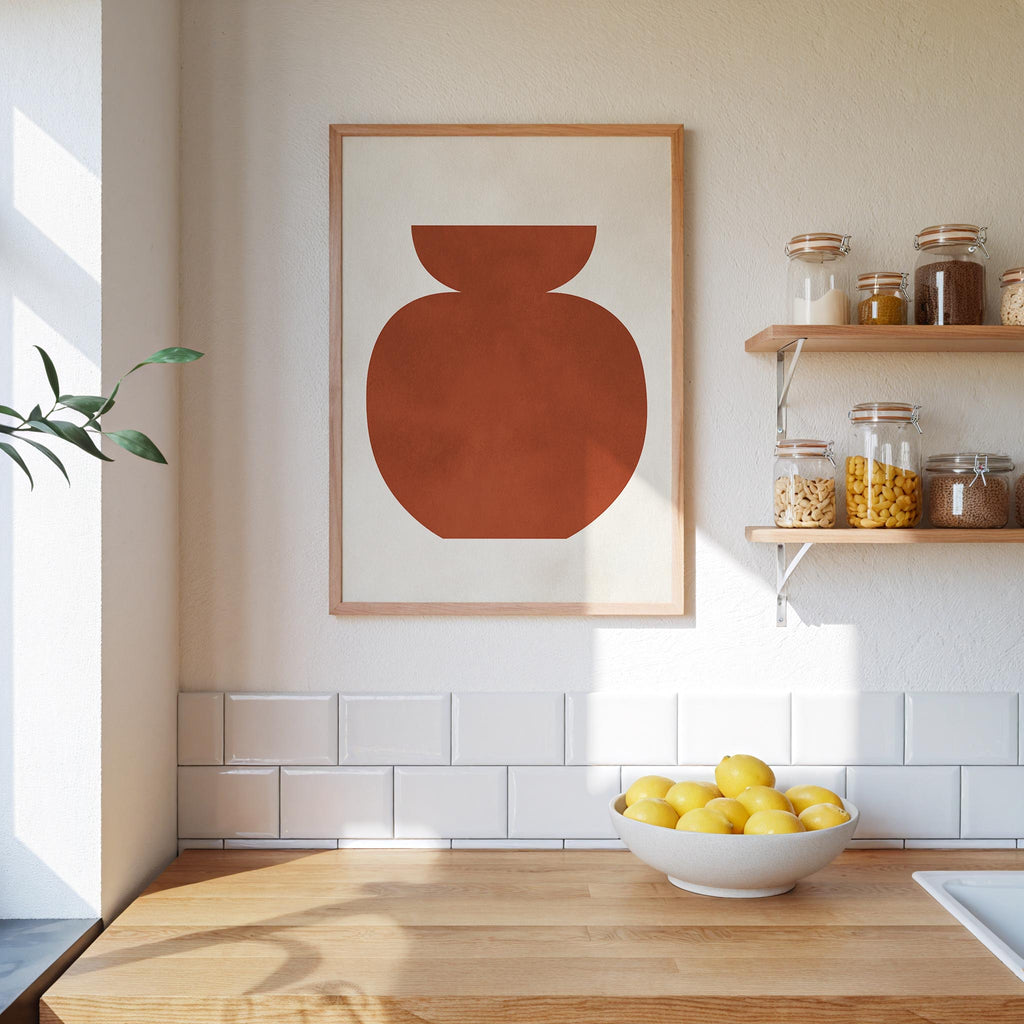 a kitchen counter with a bowl of lemons, a framed abstract artwork, and shelves displaying various jars and containers.