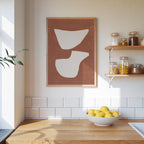 a kitchen counter with a bowl of lemons, a framed abstract artwork on the wall, and shelves displaying various jars and containers.