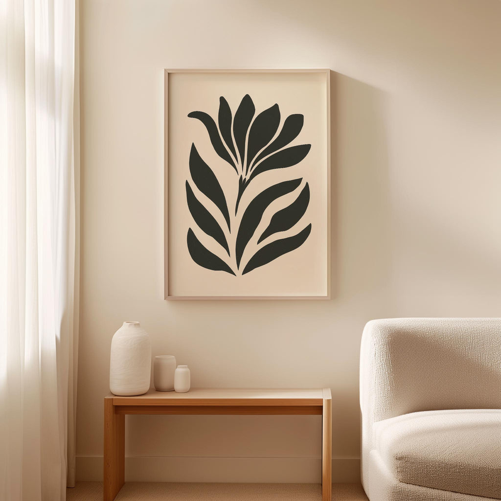 a minimalist living room with a large black and white abstract floral print hanging on the wall above a wooden side table. The table has three small white vases on it. The room also includes a white sofa and a wooden coffee table.