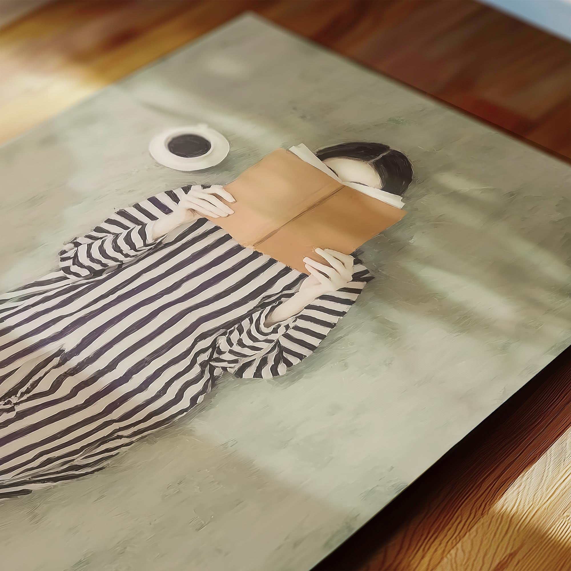 A person is lying down and reading a book, with a cup of coffee nearby.