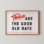 a framed poster with the text "These are the good old days" in bold, red and black lettering.